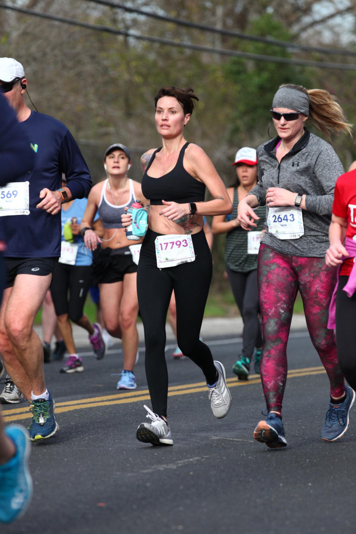 An earlier race, running with a group on a tree-lined road